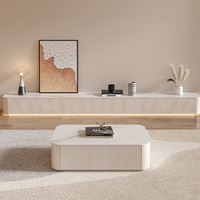 Meuble TV mural flottant blanc crème avec portes cannelées, extrémités arrondies et éclairage LED pour l'approvisionnement de projets