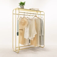 Étagère de présentation de vêtements moderne sur mesure, neuve, en acier inoxydable, pour magasin de vêtements.
