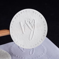 Autocollants personnalisés en papier texturé avec logo en relief, fond blanc transparent pour l'emballage