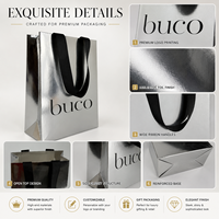 Sac en papier de luxe personnalisé avec logo, imprimé en feuille d'argent métallique, laminé, en papier d'art, avec poignée en ruban gros-grain noir pour cadeaux et achats
