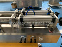 Machine de remplissage semi-automatique à double buse à piston pour l'huile comestible, les jus de fruits et les sauces