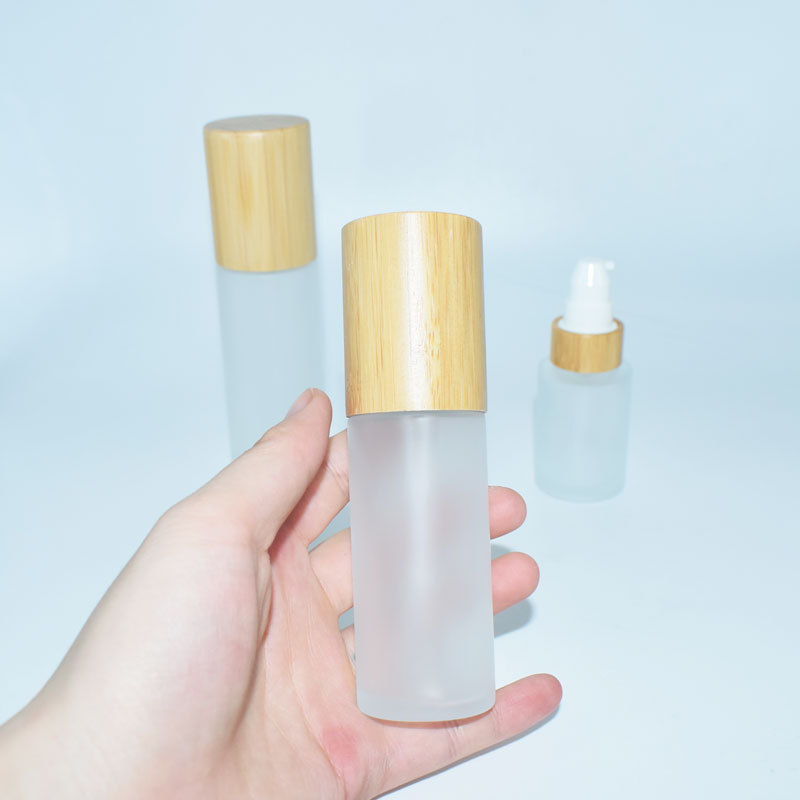 Empty clear matte cosmetic glass jar and bottle with wood lid for bamboo cosmetic packaging set