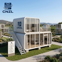 Cabane préfabriquée moderne CNZL blanche et noire avec façade entièrement vitrée, unité modulaire portable pour maison d'hôtes de station balnéaire