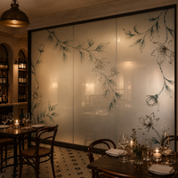 Cloison décorative en verre translucide à finition mate givrée, peinte à la main avec des motifs botaniques, pour la séparation des espaces dans les restaurants.