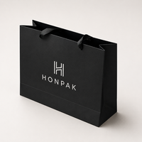 Sac cadeau de luxe en papier noir avec logo en feuille d'argent, poignée longue, taille personnalisée, emballage de boutique pour la vente au détail HONPAK