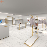 Stand d'exposition de vêtements en titane Service personnalisé à guichet unique Table de vitrine de conception de magasin entier pour magasin de vêtements