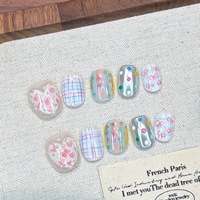 Ongles press-on faits main style niche, couleur macaron, motifs cœurs et nœuds, finition poudre miroir magique, lignes blanchissantes, amovibles