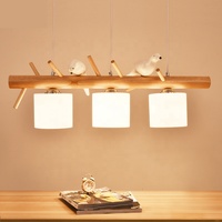 Lustre moderne japonais simple à LED Lampe de salle à manger en bois massif sur le thème des oiseaux pour table à manger à trois têtes à usage domestique