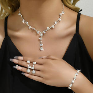 Conjunto nupcial de tres piezas con incrustaciones de diamantes, collar, pendientes y pulsera de cristal chapados en plata - Joyería de boda moderna para mujer - Product Image 1