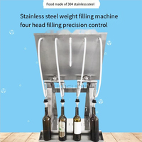 Machine de remplissage par gravité à 4 becs pour vins, spiritueux et jus de fruits dans des bouteilles en verre ou en plastique