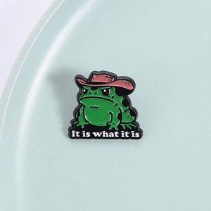 Pin de esmalte de rana vaquera de dibujos animados con diseño 'It Is What It Is', divertido humor occidental, broche de rana vaquera, insignia para mochila y solapa, regalo de joyería - Product Image 1