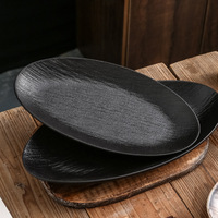 Service de vaisselle Assiette japonaise ovale noire et bleue de luxe avec design moucheté texturé Vaisselle en porcelaine de haute qualité