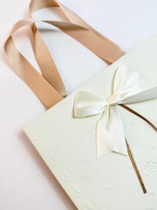 Custom Creative Ivory Board Paper Women Gift Bag <b>With</b> Flat Handles Embossed Design Ribbon <b>Bow</b> Rectangle Gift Bag For Clothes - Product Image 3
