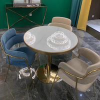 Hôtel nordique moderne luxe métal PU cuir rembourré chaise de salle à manger de luxe Table en marbre ensemble groupe pour 4 personnes