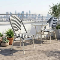 Chaise de salle à manger d'extérieur en rotin PE tressé en V blanc et noir, design français, imperméable, empilable pour hôtel, parc, événement, mariage