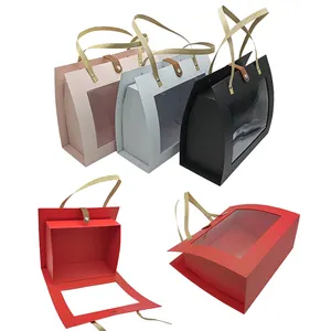صندوق هدايا زفاف من الورق المقوى مخصص على شكل حقيبة يد بمقبض ورقي لتعبئة المنتجات مع نافذة شفافة