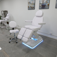 Chaise de tatoueur moderne haut de gamme lit de spa électrique réglable pour le visage table de massage de salon de beauté avec lampe à led
