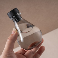 Flacon diffuseur rond en verre gris de luxe de 100 ml avec couvercle hermétique pour l'affichage et la recharge d'huiles parfumées pour la maison