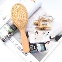 Brosse à cheveux ovale en bois compacte ionique la plus vendue avec picots métalliques et fonction laser pour massage capillaire, pour femmes