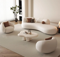 Canapé modulaire incurvé de luxe en cuir PU crème, style moderne et minimaliste, avec coussins ronds, pour salon, centre commercial et hôtel