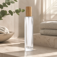 Flacon de parfum rond en verre transparent personnalisé de 100 ml, pulvérisateur à vis XB150, bouchon en bambou, emballage de parfum de luxe rechargeable, logo OEM