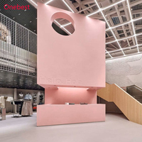 Comptoir de caisse moderne en surface solide rose pour magasin de vêtements pour femmes et dames, kiosque d'accueil, présentoir