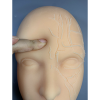 Tête de mannequin d'entraînement aux injections faciales en silicone KyrenMed, entièrement en silicone souple avec des os et des localisations des vaisseaux sanguins sur la moitié du visage
