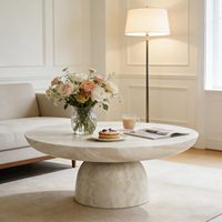 Table basse ronde contemporaine sur piétement avec finition en pierre naturelle