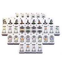 Jeu de tuiles de Mahjong sur le thème d'Halloween avec des motifs de fantômes, de cercueils, de toiles d'araignées, d'hiboux et de chaudrons magiques pour les divertissements des fêtes