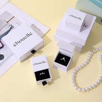 Emballage cadeau sophistiqué pour bijoux en ivoire A1 avec tiroirs de présentation noirs et architecture de boîtes multi-tailles raffinée