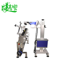Machine de marquage laser UV à positionnement automatique sur convoyeur à rouleaux pour tubes cosmétiques ronds, avec marquage de la date de production et impression de logo laser