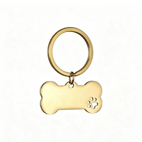 Porte-clés tendance en acier inoxydable, forme d'os avec empreinte de patte mignonne, gravure personnalisée, anti-perte, finition brillante, avec anneau fendu