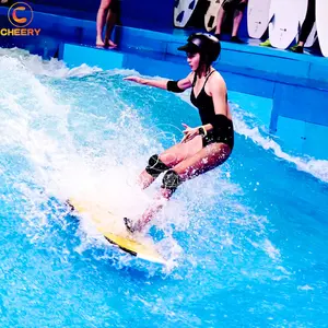 Surfing on artificial wave indoor amusement park surfing simulator machine swimming pool wave machine