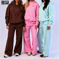 Ensemble deux pièces à capuche pour femme, haut zippé à manches longues et pantalon large, survêtement décontracté ajusté, couleur unie, vente en gros