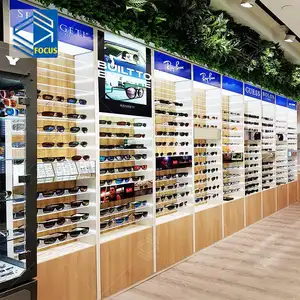 نظارات شمسية أنيقة للبيع بالتجزئة شاشة حائط مع درج قاعدة تخزين لمتاجر النظارات تصميم داخلي لمتجر النظارات البصرية