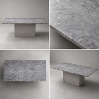 Table basse contemporaine en pierre gris clair avec base moderne en ciment, personnalisable pour les projets hôteliers et de villas