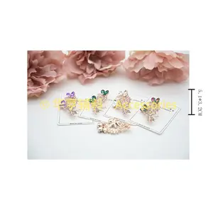 Vente en gros de petites broches montées sur des cartes de mode européennes et américaines incrustées d'une broche en alliage de strass, tissu de fleurs à main