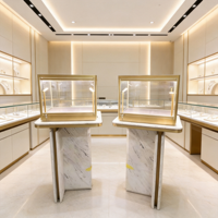 Présentoir à bijoux de luxe en marbre avec cadre doré et éclairage LED pour boutique – Solution de mobilier