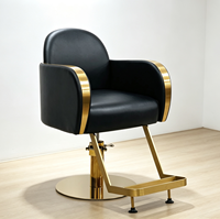 Chaise de barbier haut de gamme avec dossier incurvé et finition dorée élégante pour salon de coiffure professionnel