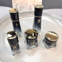 OEM ODM Personnalisé Luxe 100ml 120ml Huile Cosmétique Crème Soin de la Peau Soins Personnels avec Bouteille en Verre Rond Blanc Or Noir