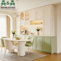 Buffet de cuisine sur mesure avec portes cintrées crème, base Shaker vert sauge et étagère à niche ouverte avec éclairage LED