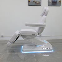 Chaise de tatoueur moderne haut de gamme lit de spa électrique réglable pour le visage table de massage de salon de beauté avec lampe à led