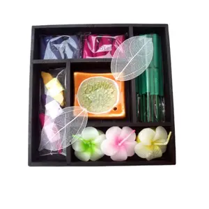 Mini scented candles and incense sticks in flower wooden holder