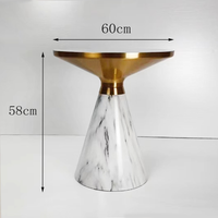 Table d'appoint contemporaine 2026 présentant un élégant plateau en pierre frittée et une base en métal sculpté, élégante et simple