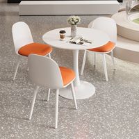 Ensemble de salle à manger de luxe moderne avec table ronde en marbre et chaises rembourrées pour petite cuisine et villa
