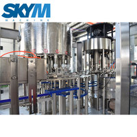Machine de remplissage et de bouchage automatique SKYM pour petites bouteilles de Zhangjiagang, idéale pour l'huile d'olive et les huiles comestibles