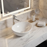 Vasque en céramique ovale de petite taille à surface lisse moderne pour salle de bain et hôtel, vente en gros