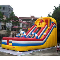 Structure gonflable commerciale en PVC pour dinosaures, avec toboggan sec et aquatique, idéale pour la location événementielle
