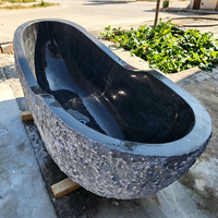 Baignoire d'angle autoportante de luxe en marbre noir foncé irrégulier, en pierre naturelle, pour hôtel et maison, style béton, vente en gros