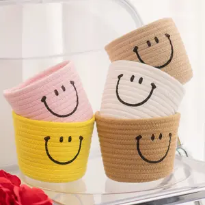 Cesta de almacenamiento de diseño de cara sonriente, cesta de almacenamiento colgante de diseño trenzado de tela moderna para el hogar